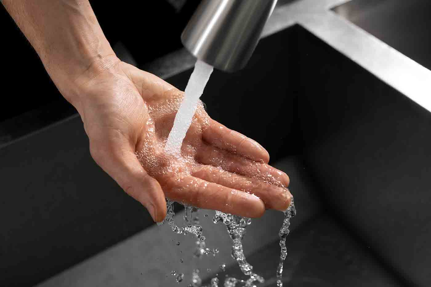 A plumber fixing a pipe to resolve low water pressure issues