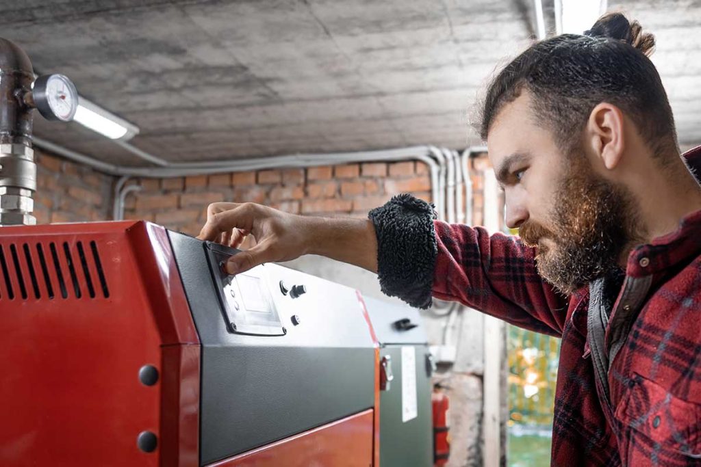 Boiler engineer performing servicing in a Brixton home