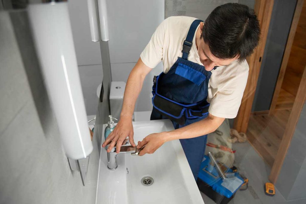 Plumber repairing a faulty boiler in a London home