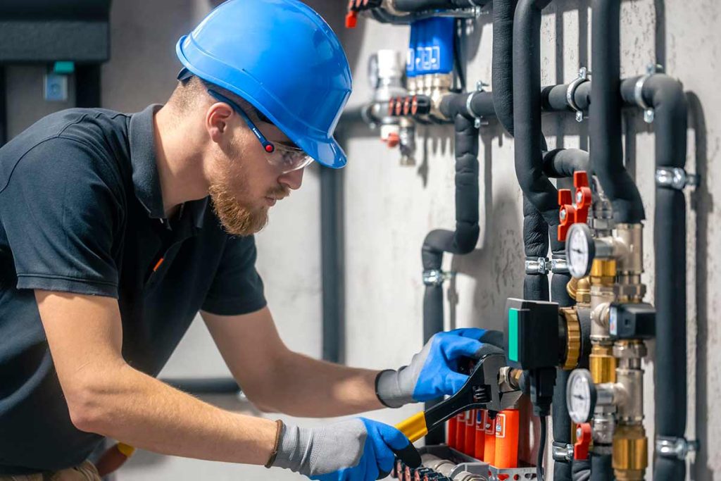 Professional boiler engineer servicing a system in a Clapham home